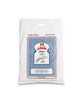 A white plastic bag of cotton bed sheets with a blue, white, and red printed label on the front, set against a plain white background.